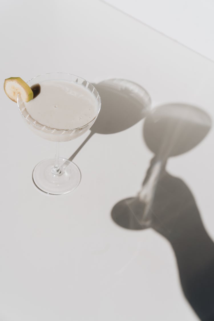 Wineglass With Banana Slice And Shadow Hand With Wineglass