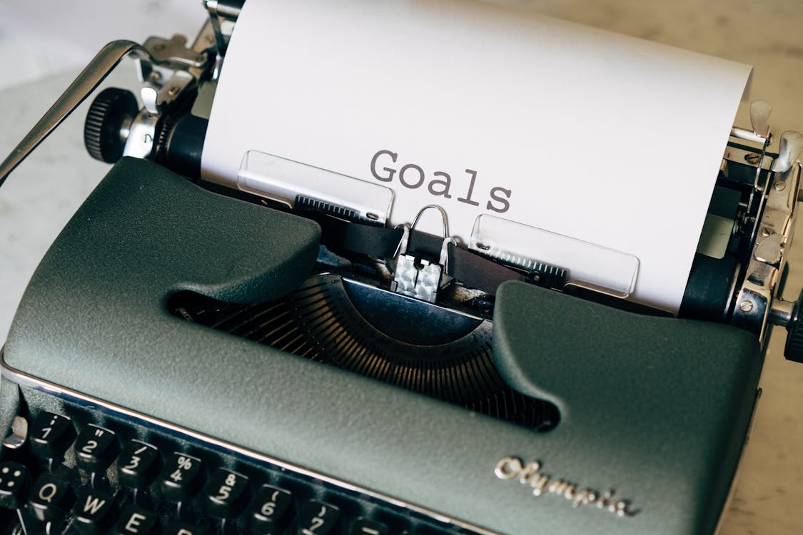 Free Green Typewriter on Brown Wooden Table Stock Photo