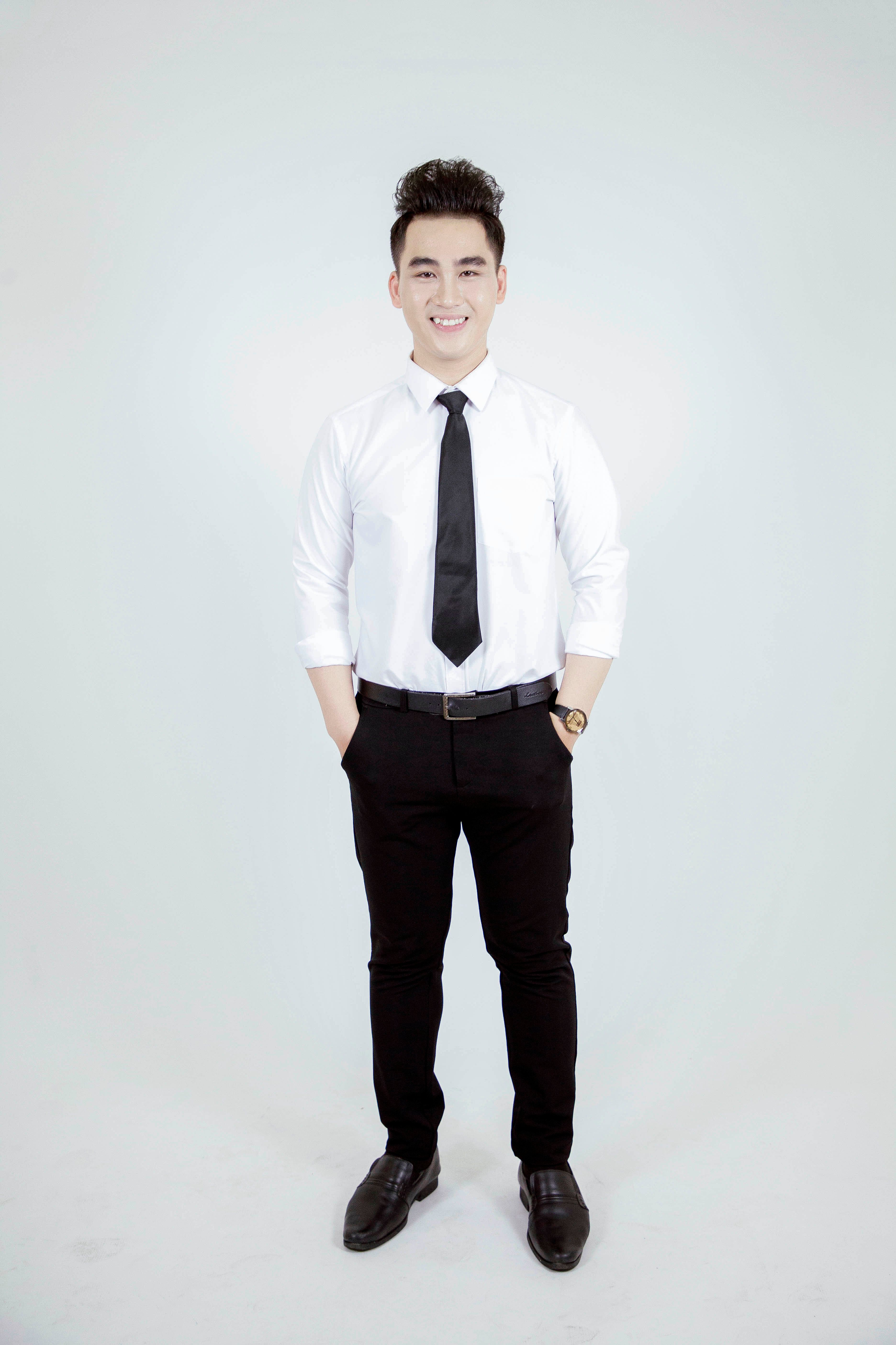 Confident Young Man in Formal Attire on White Background · Free Stock Photo