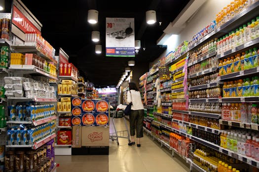 Vibrant supermarket aisle scene with a shopper in Jawa Timur, Indonesia.