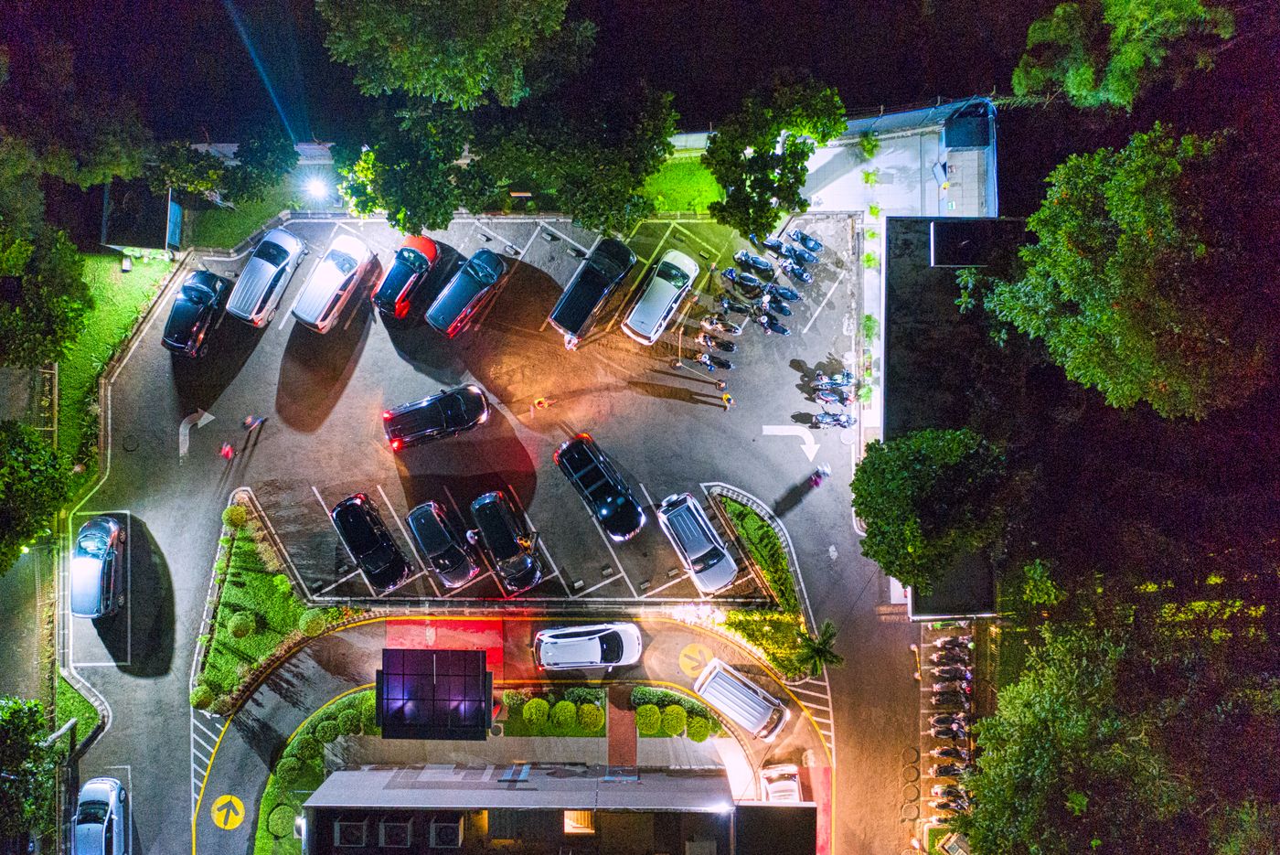Vista aérea de un estacionamiento de noche iluminado por faroles