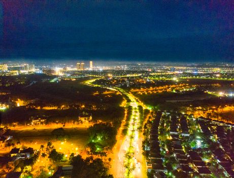 A breathtaking aerial view of Banten, Indonesia at night showcasing illuminated city lights and road networks.