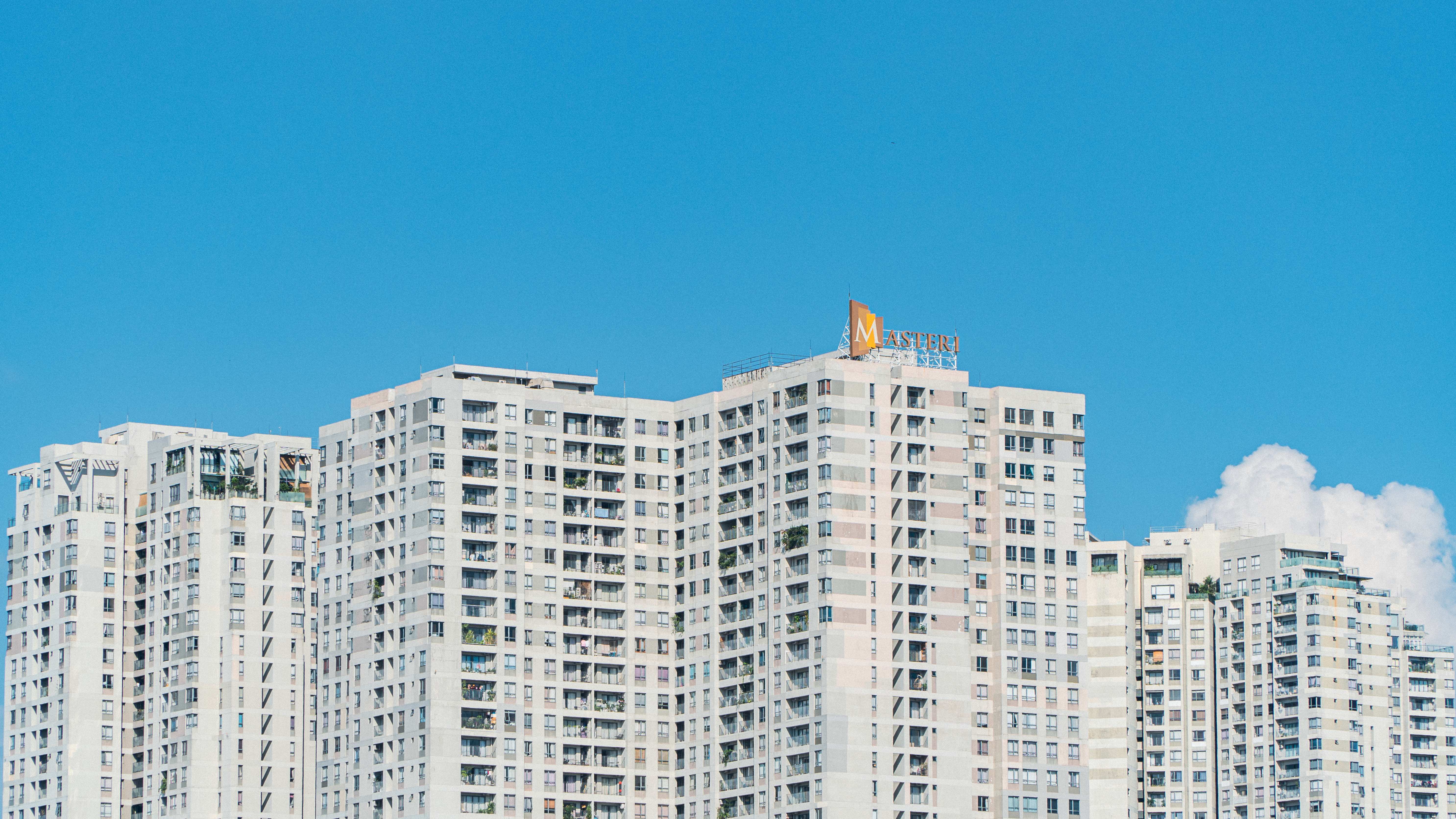 High-rise apartment skyline under blue sky · Free Stock Photo