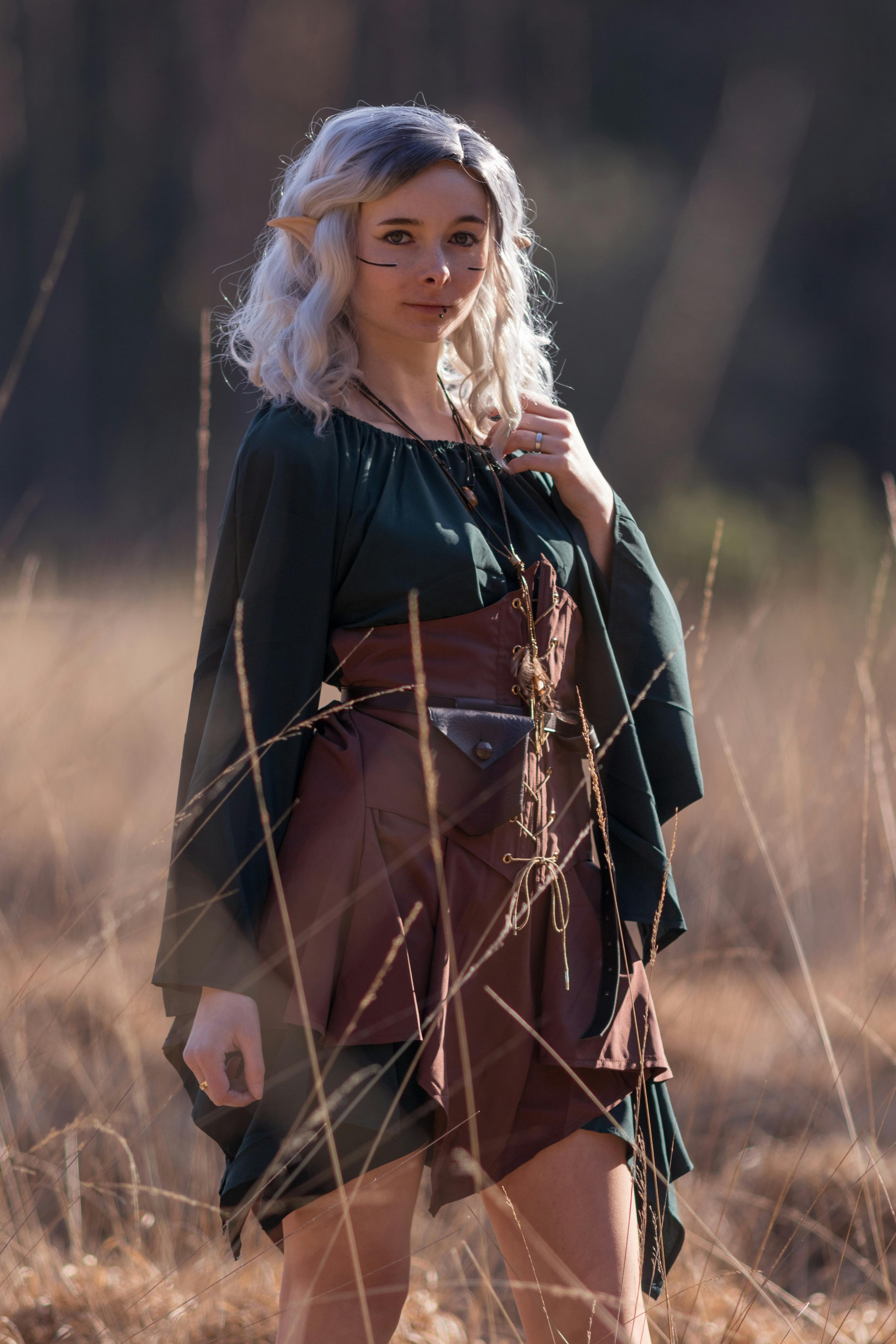 Enchanting fantasy cosplay of woman in nature with creative costume and accessories.