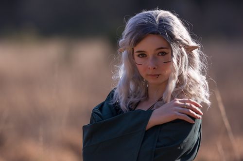 Free A captivating elf cosplay portrait outdoors with fantasy makeup and ears. Stock Photo