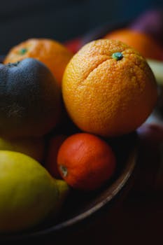 Close-up of mixed citrus fruits in a bowl, showcasing freshness and vibrant colors.
