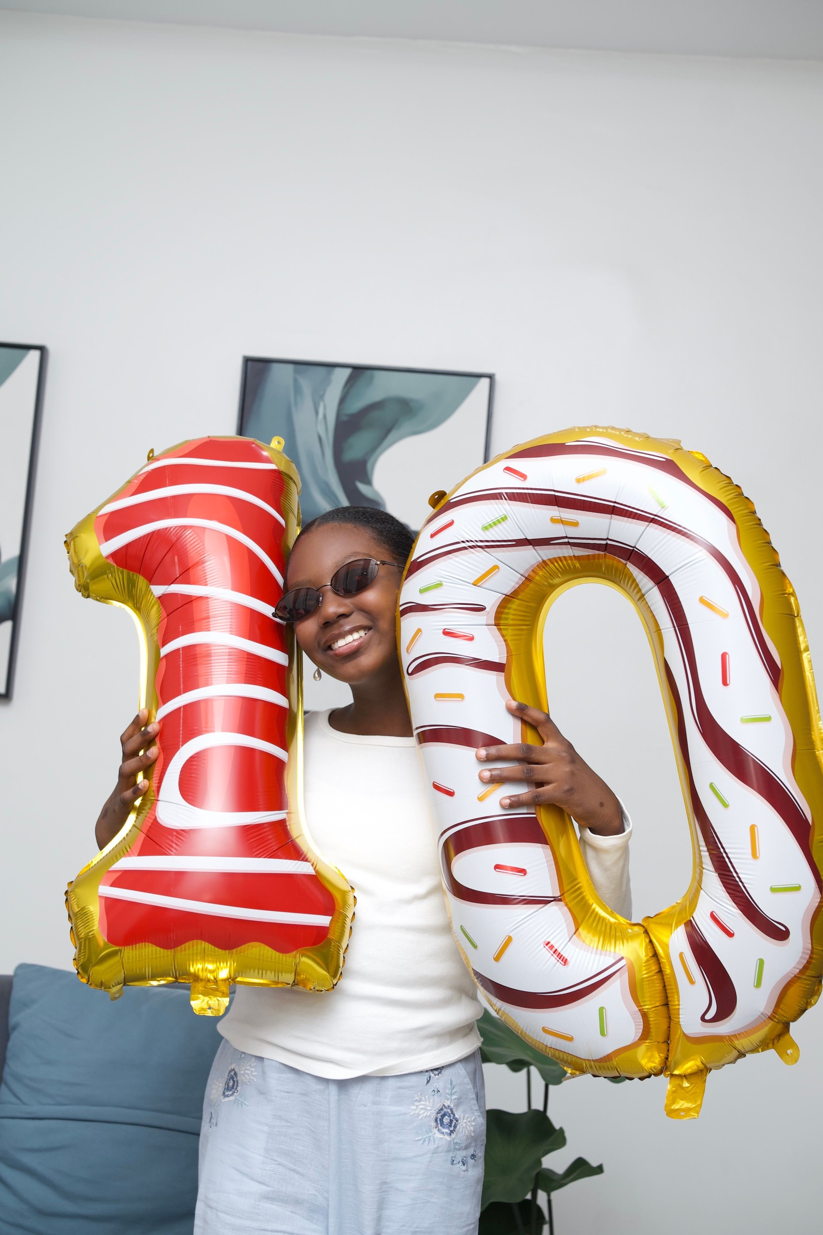 Celebratory Portrait of Young Girl Holding Balloons · Free Stock Photo