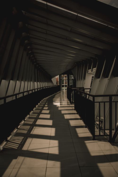 Free A striking modern hallway featuring geometric patterns and shadows in Semarang, Indonesia. Stock Photo