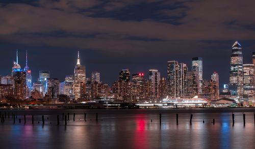 Free Beautiful view of New York city's skyline at night with reflections on water. Stock Photo