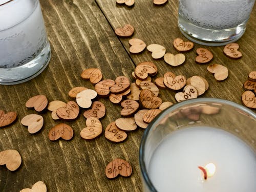 Lit Candles and Little Wooden Heart Decorations