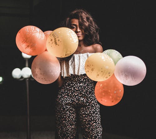 Photo Of Woman Holding Balloons