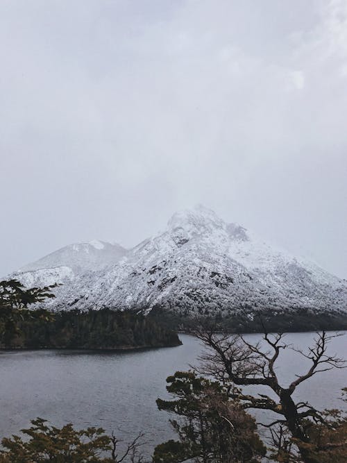 Snow Covered Mountain Near Body of Water