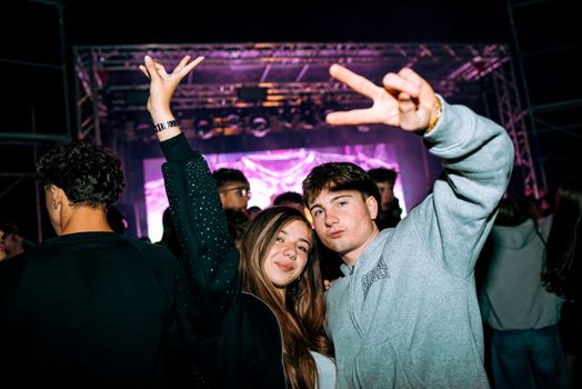 Energetic young adults enjoying a vibrant night party in Slovakia. Perfect event atmosphere.