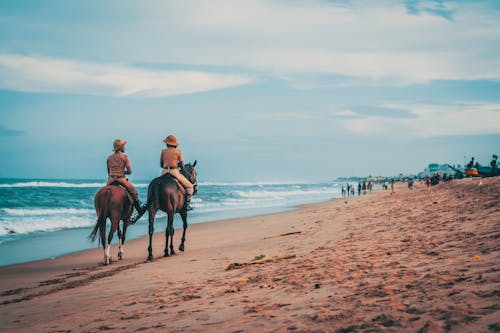 Photo Of Men Riding Beside Sea