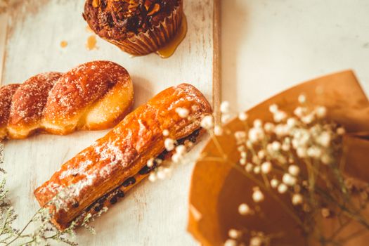A delightful selection of rustic pastries including a muffin and danish, perfect for dessert lovers.