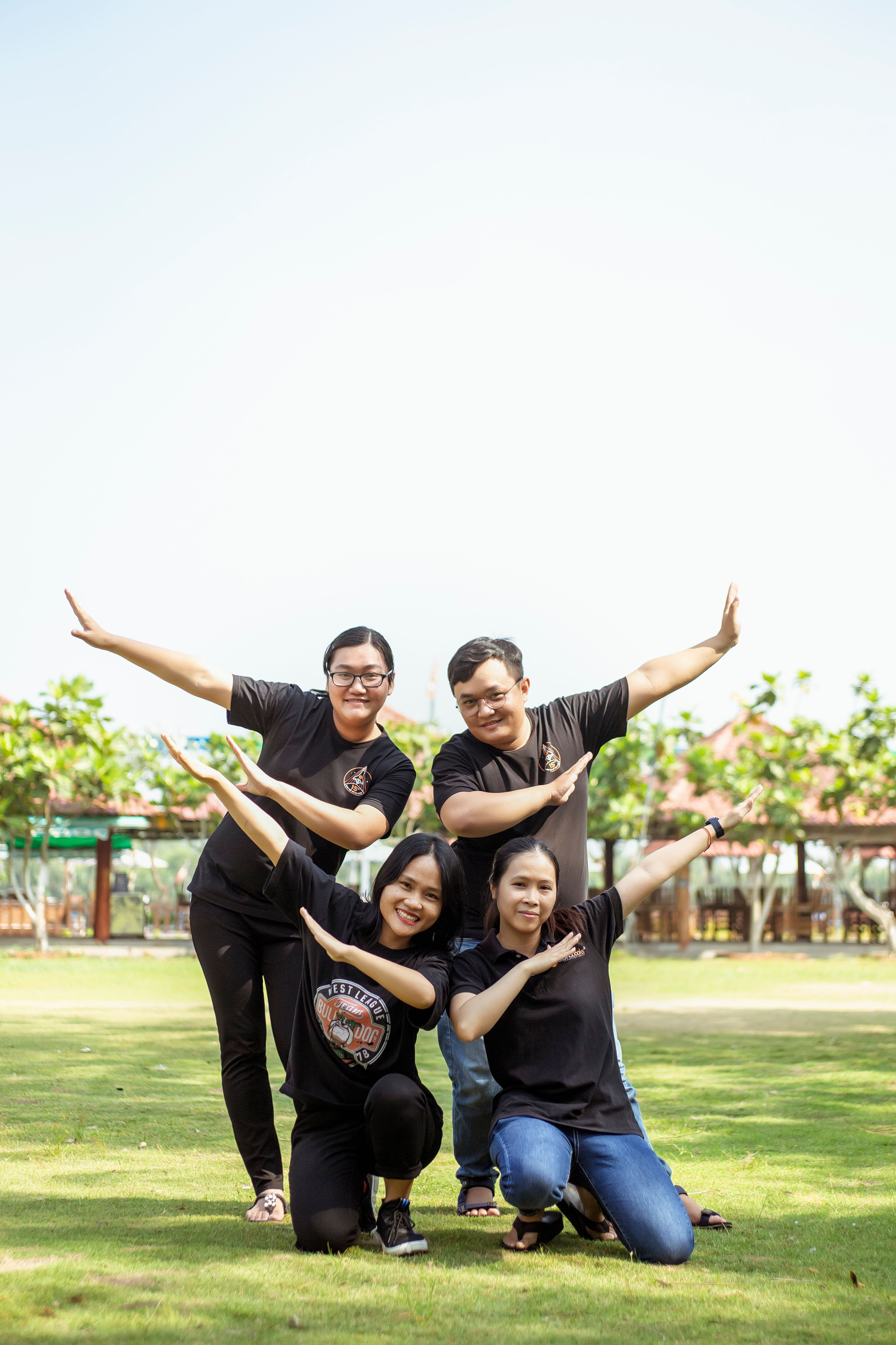 People in Black Shirts Standing on Green Grass Field · Free Stock Photo