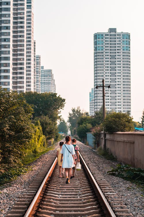Photo Of People Walking On Railroad
