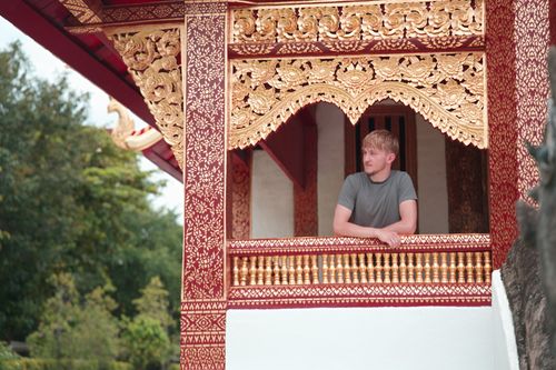 Free A tourist enjoys a serene view from Wat Phra Singh in Chiang Mai, Thailand. Stock Photo