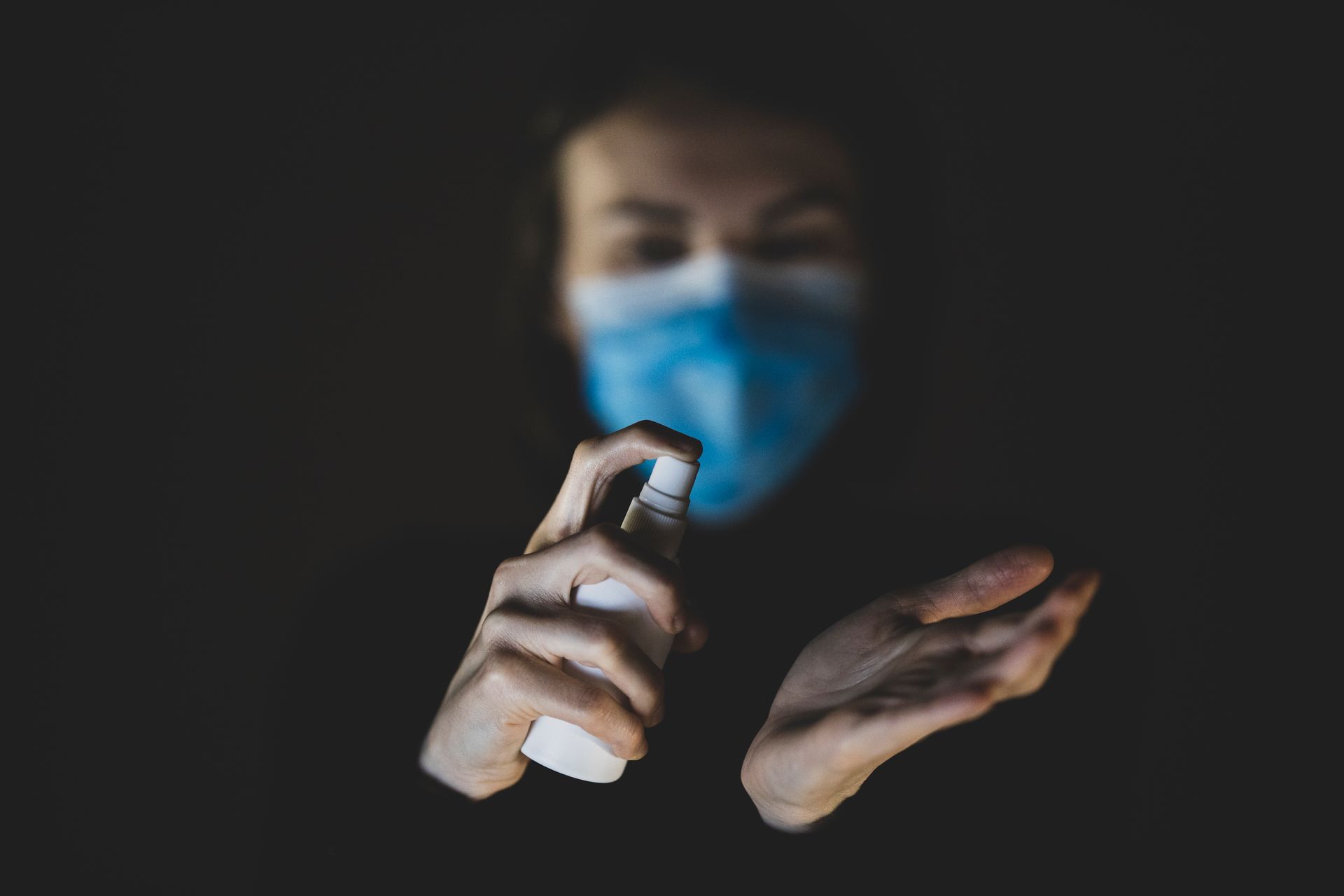 Person Holding Spray Bottle