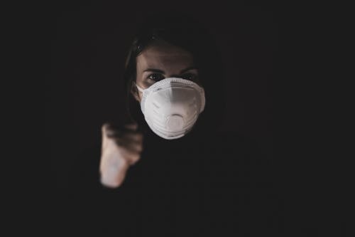 Woman in Black Shirt Wearing N95 Mask