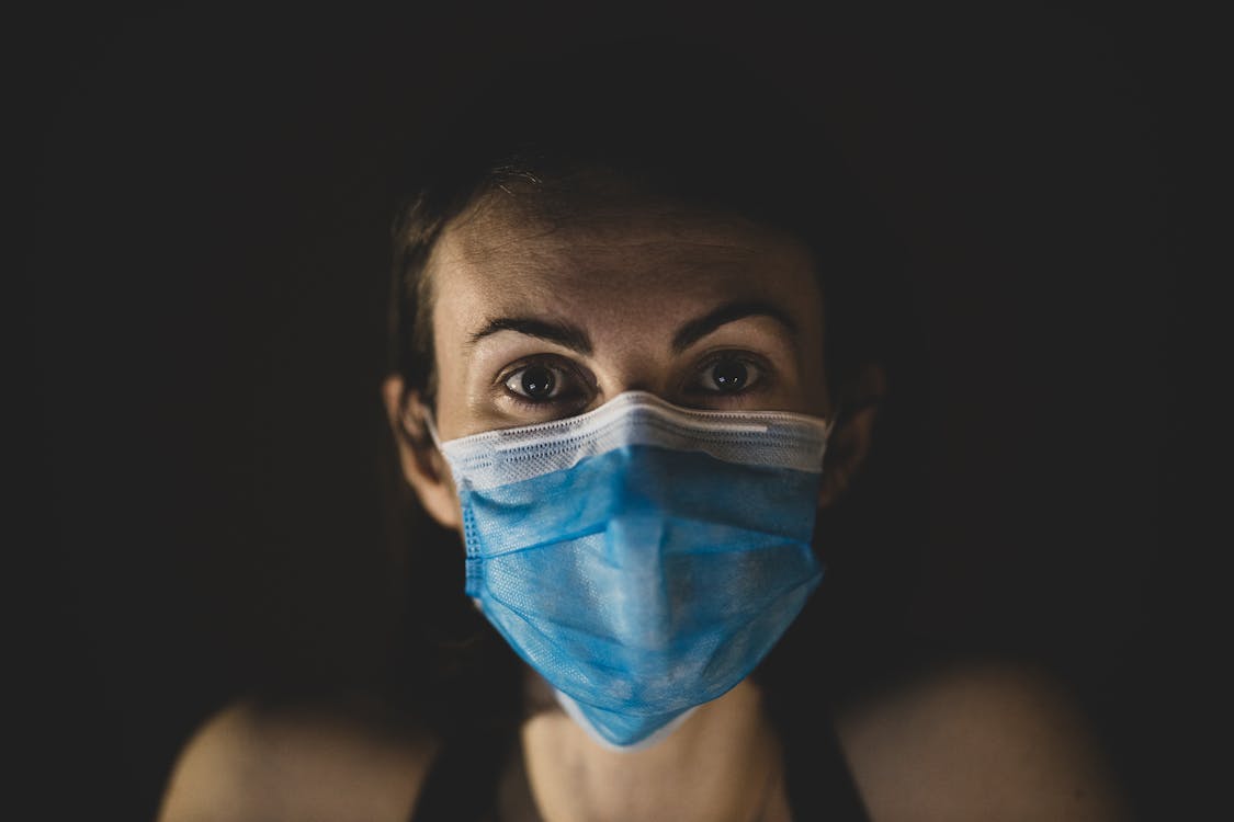 Free Woman Wearing A Blue Surgical Face Mask Stock Photo