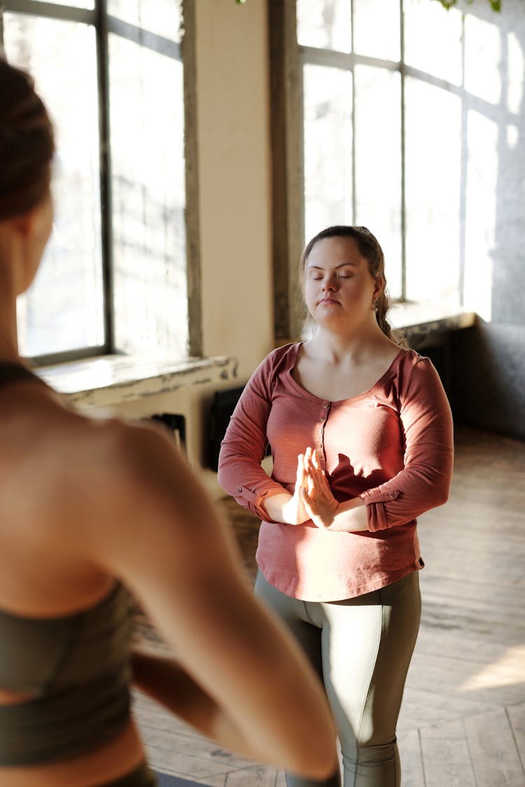 Woman In Long Sleeves And Leggings Meditating