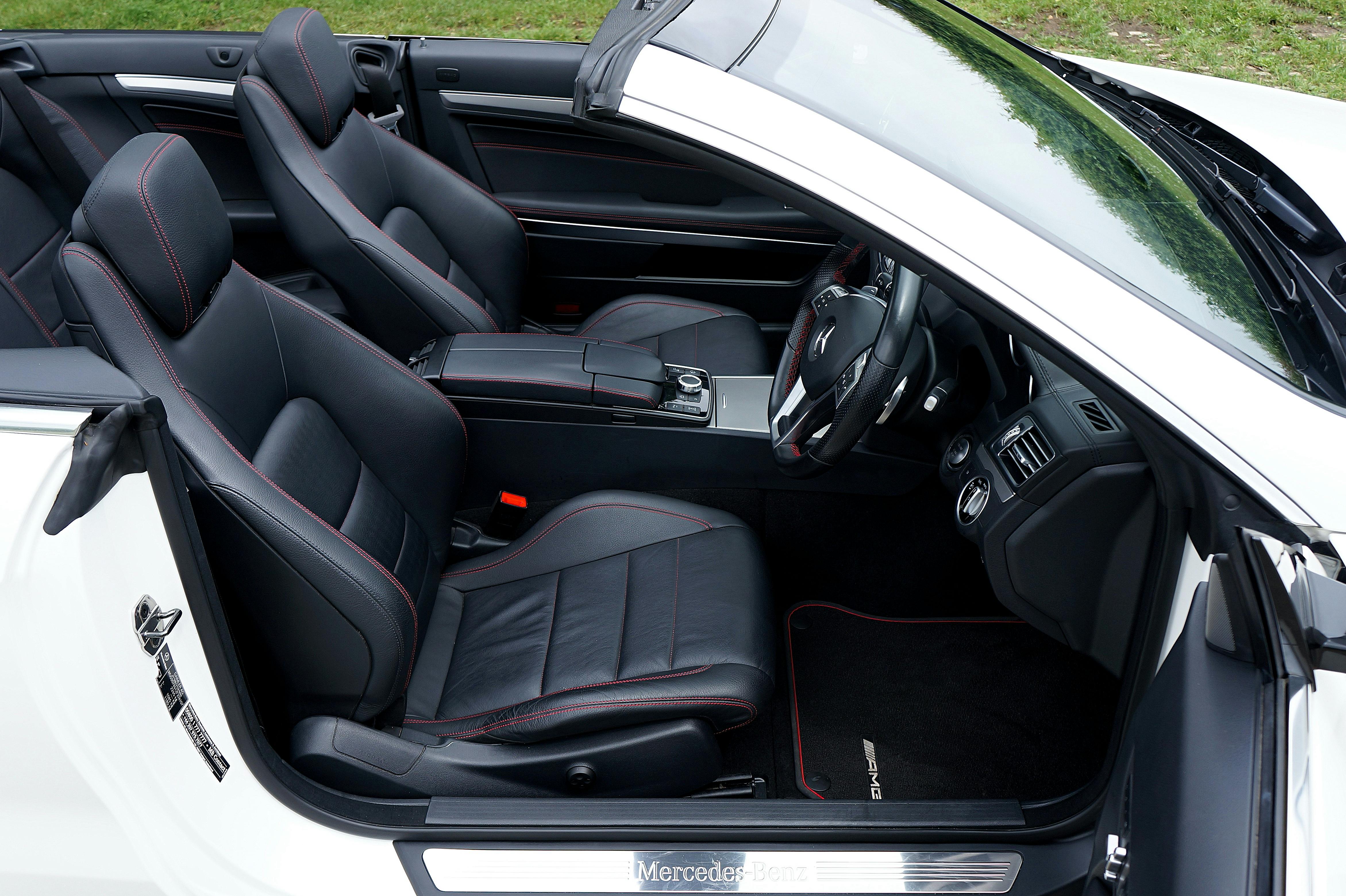 Explore the elegance of a luxury convertible car interior featuring premium black leather seats and detailed craftsmanship.