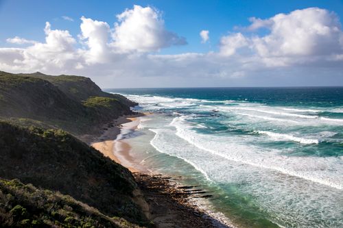 Free Breathtaking view of the coastal landscape in Queensland, Australia, with crashing waves and lush greenery. Stock Photo