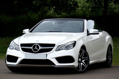 Free White Mercedes-Benz convertible car parked outdoors showcasing luxury and style. Stock Photo