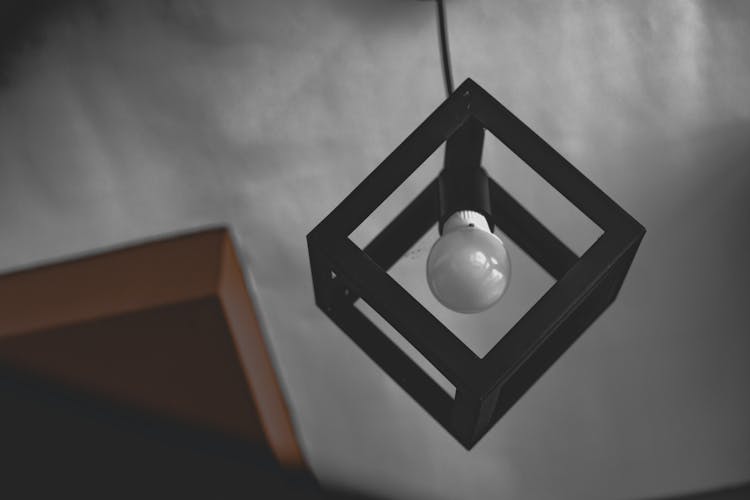 Hanging White Light Bulb On Black Frame