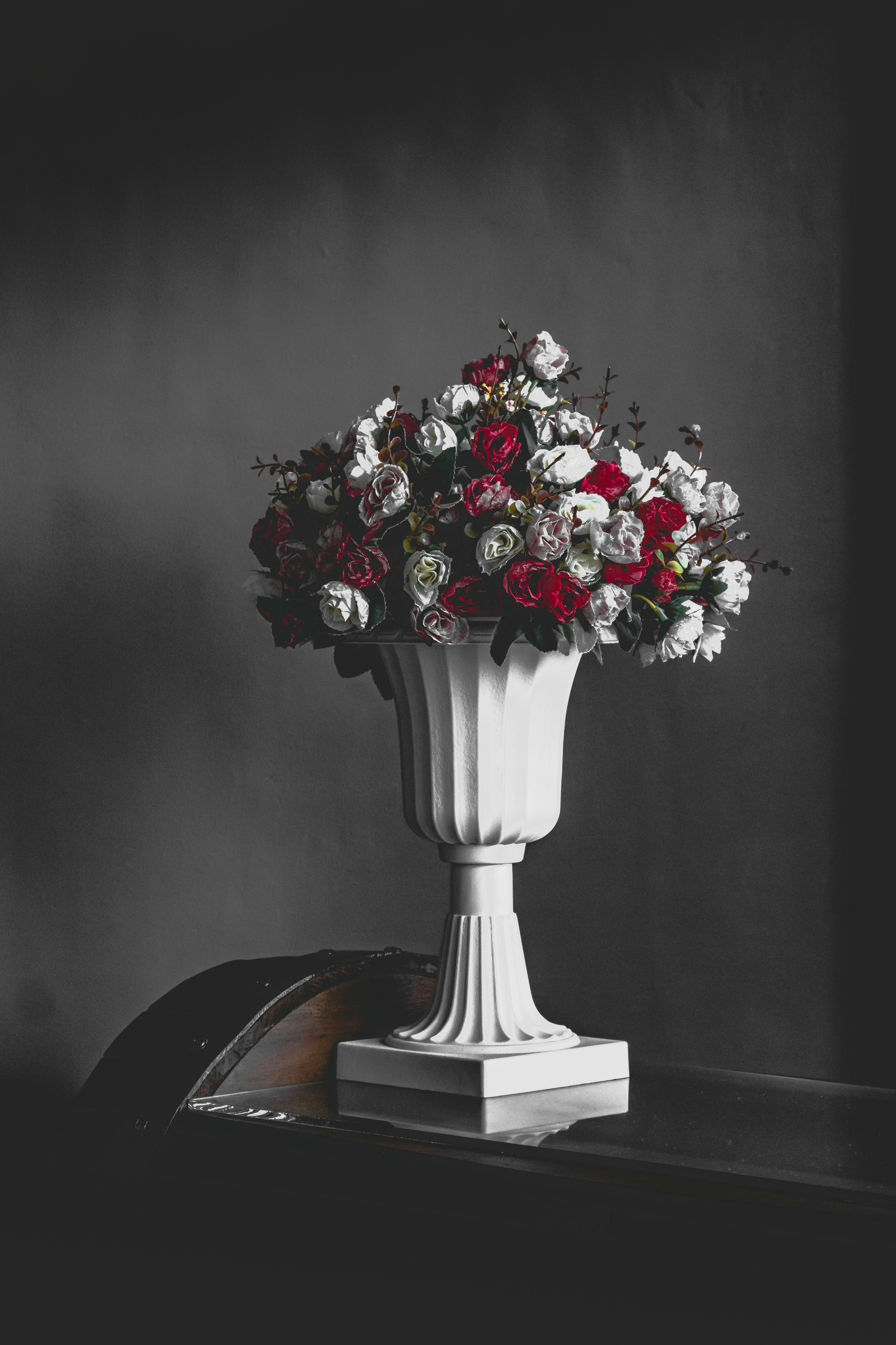 A beautiful bouquet of red and white roses in a classic vase, perfect for romance and decoration.