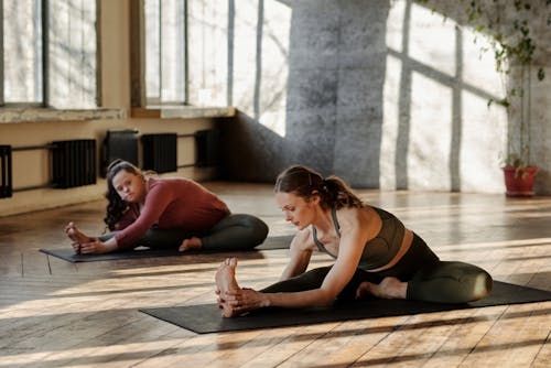 Photo Of Women Stretching Together