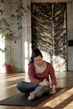 Woman with disability practicing yoga indoors, focusing on wellness and relaxation.