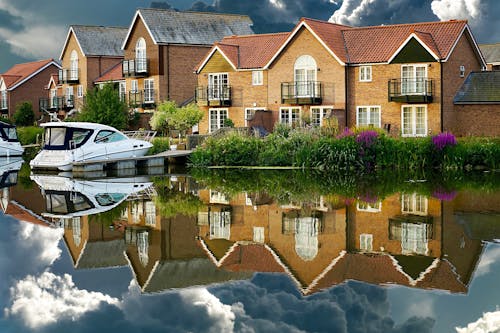 Brown and White Concrete House Near Body of Water