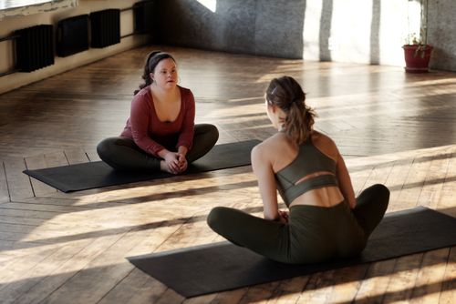 Free Two women practicing yoga indoors, embracing diversity and wellness. Stock Photo