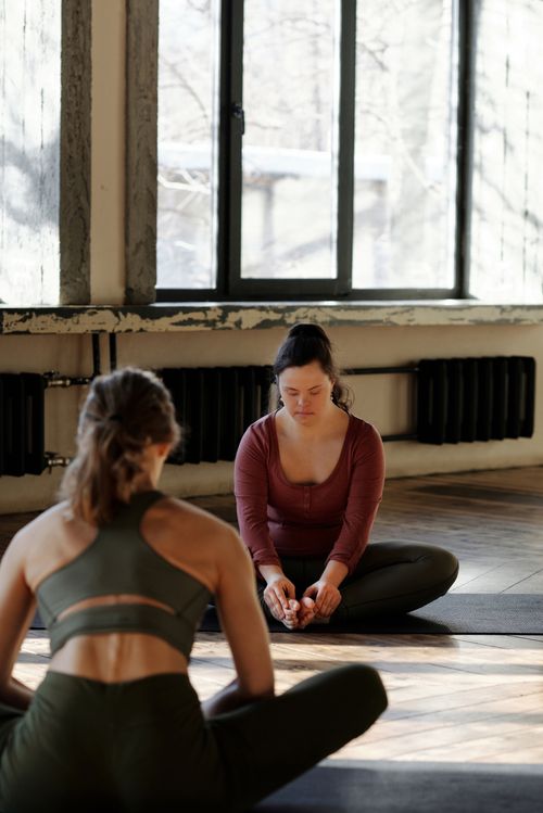 Free Two women practicing yoga in a calm indoor setting, focusing on relaxation and wellness. Stock Photo
