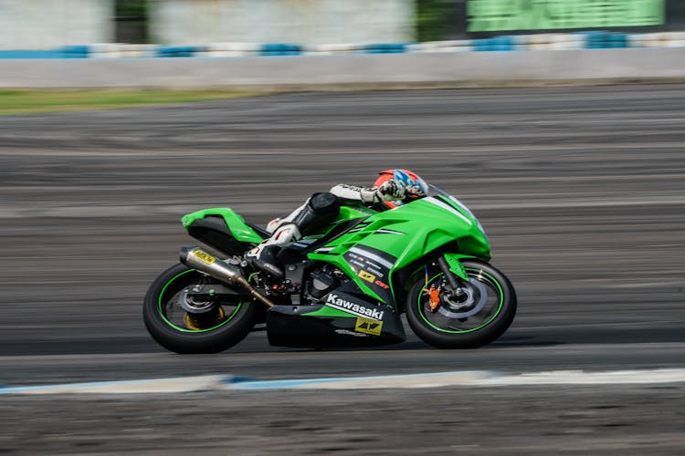 Man Riding On Green Sports Bike