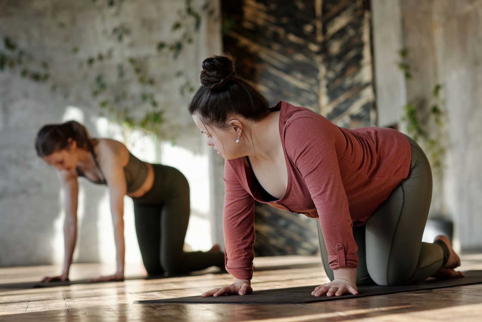 Instructor guiding a class through a spine-strengthening standing stretch