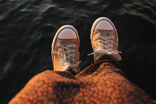 Free Person Wearing Brown and White Sneakers Stock Photo