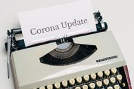 A Vintage Typewriter With Corona Update Typed On White Paper