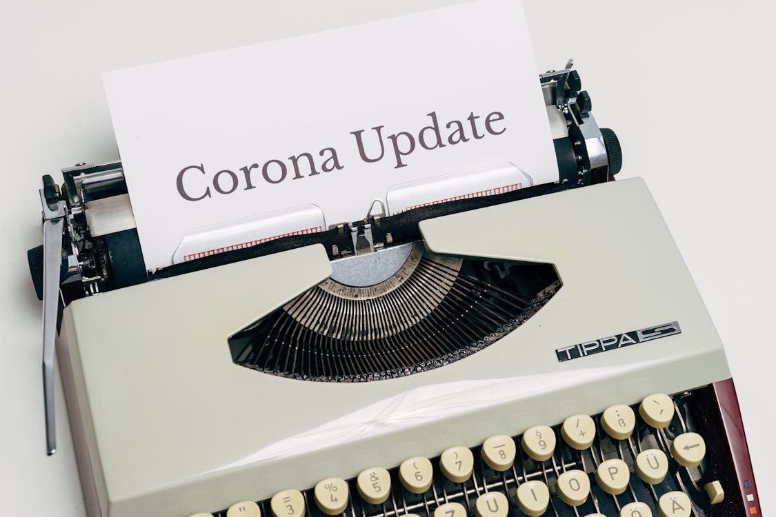 Free A Vintage Typewriter With Corona Update Typed On White Paper Stock Photo
