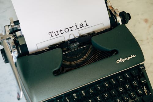 Green Typewriter on White Table