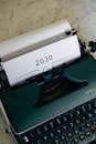 Green and White Vintage Typewriter With White Paper