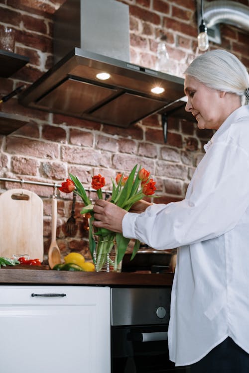 Foto profissional grátis de adulto, arranjo de flores, casa