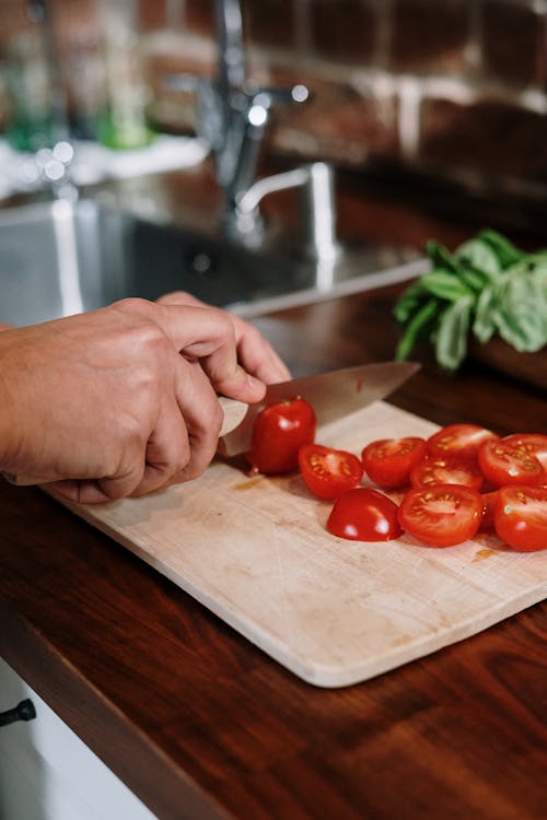 Photo Of Person Slicing Tomatoes