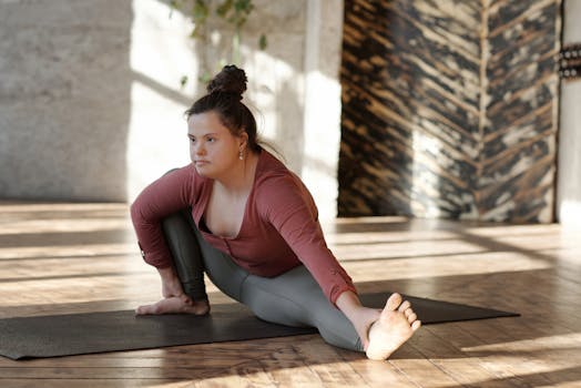 A woman practicing yoga in a bright studio, embodying flexibility and concentration.