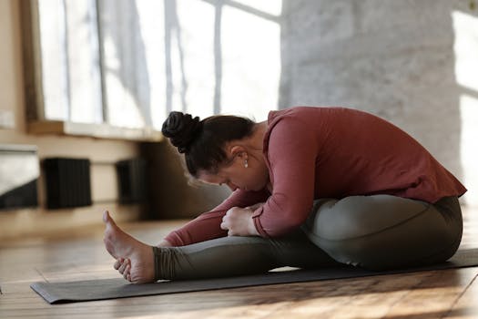 Woman with Down syndrome practicing yoga indoors, focusing on relaxation and wellness.
