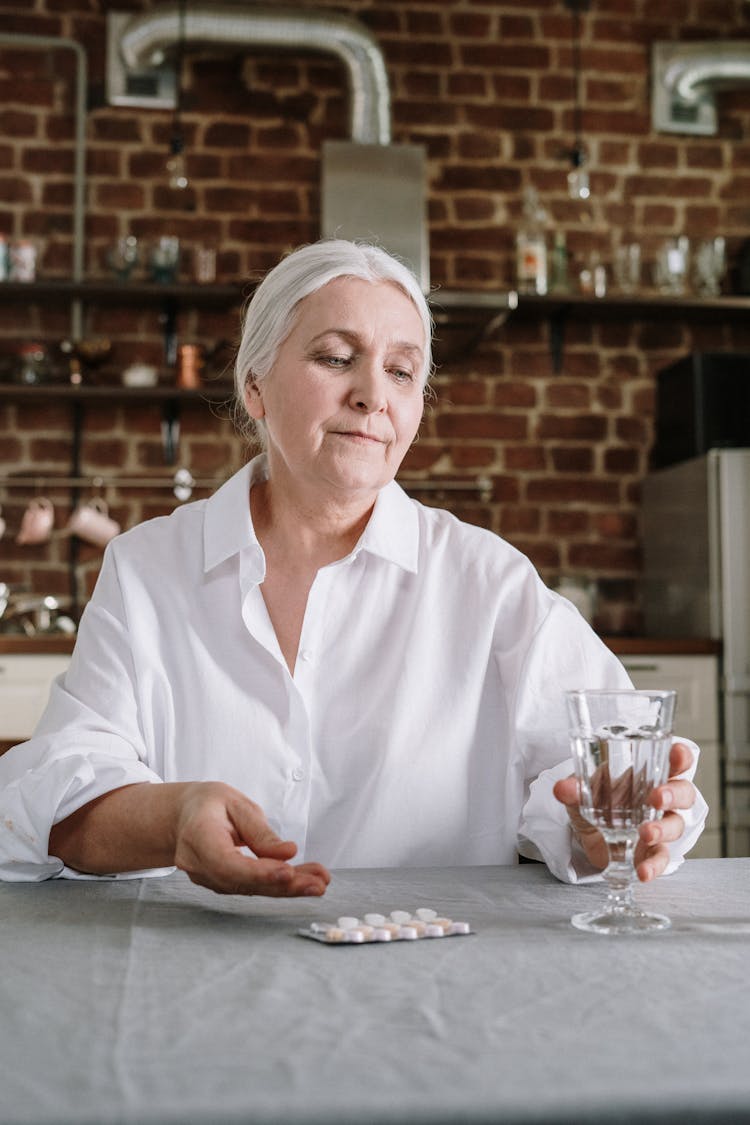 An Elderly Woman Taking Her Medicines