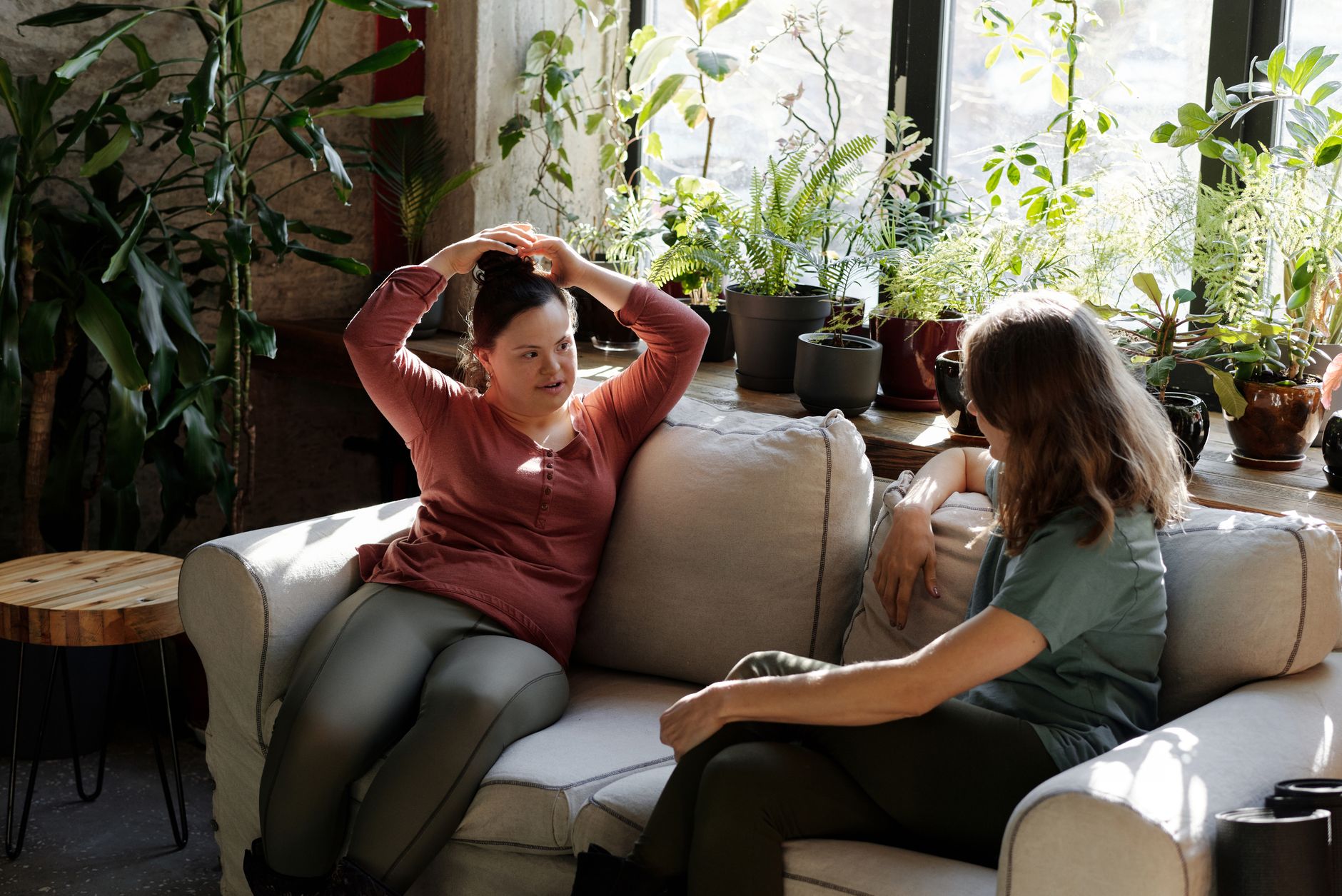 Two people seated in conversation, one leaning forward and listening closely