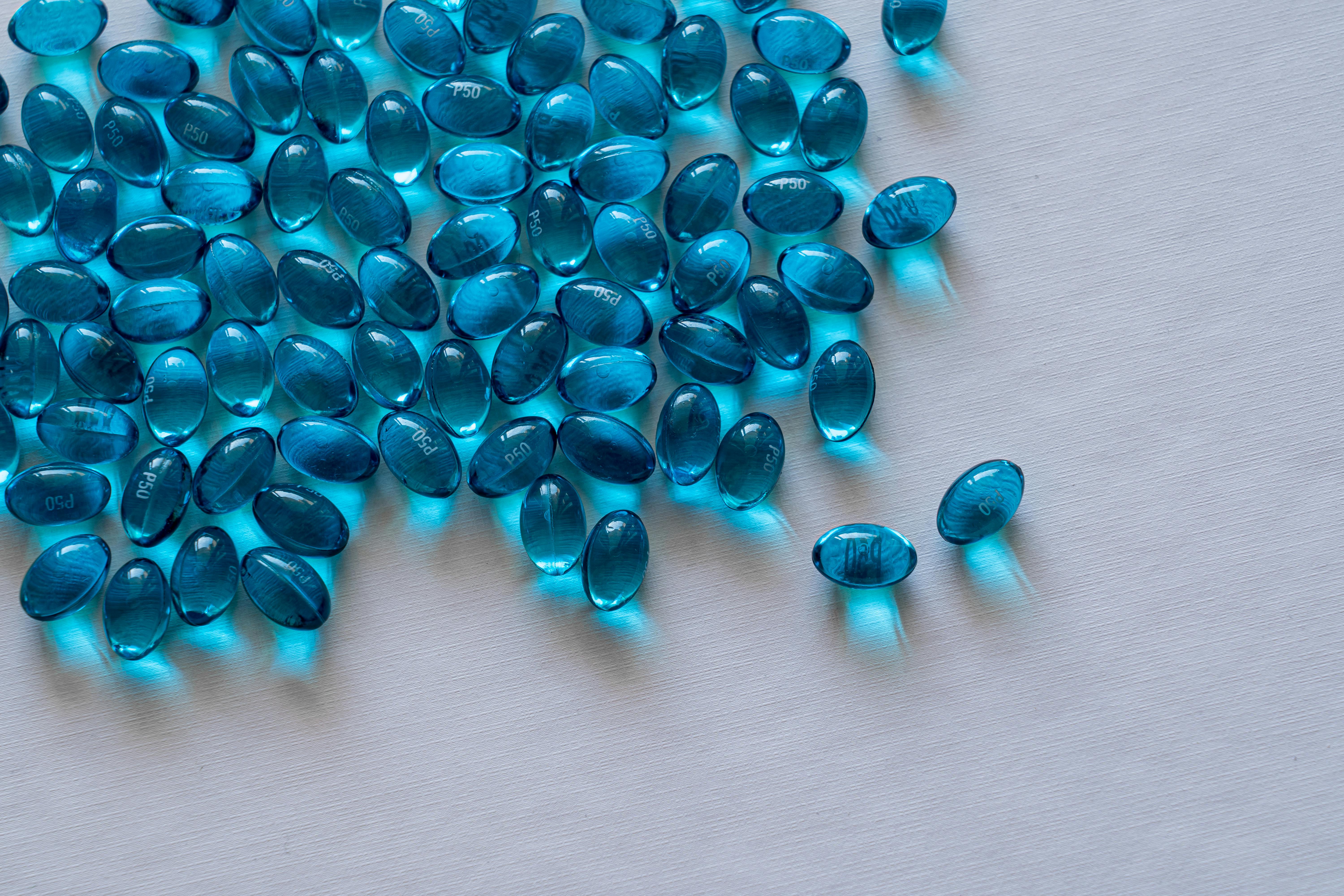 Blue Beads on White Surface · Free Stock Photo